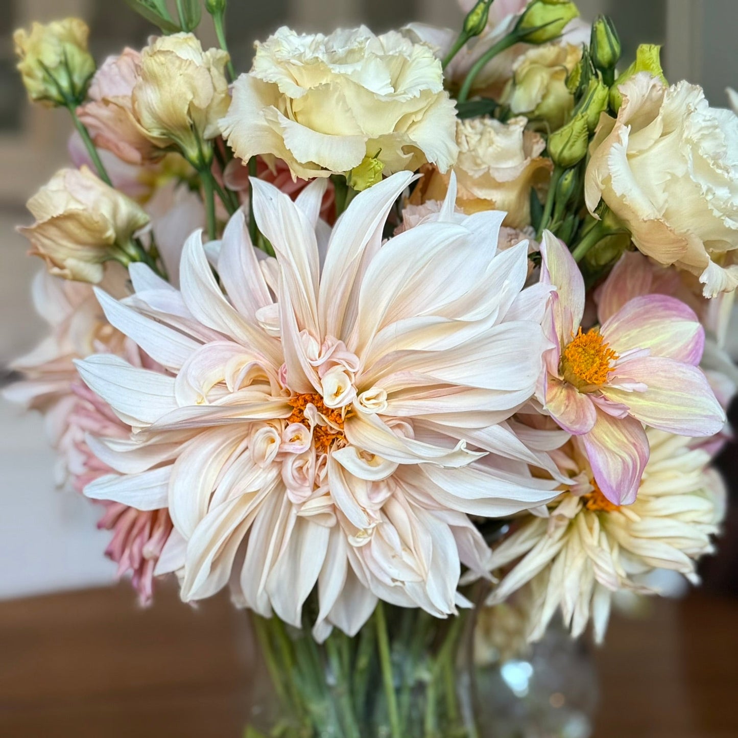 Bouquet of flowers in a clear vase on a wooden surface