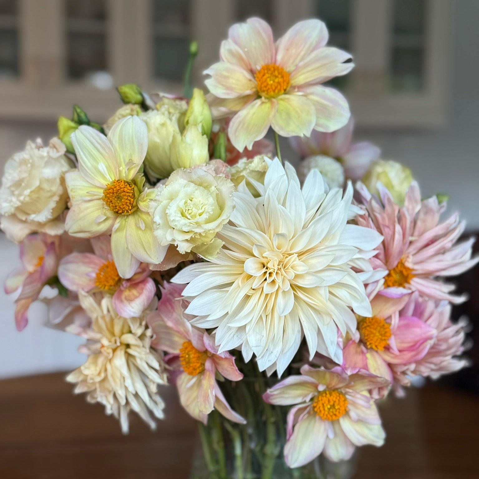Bouquet of flowers in a clear vase on a wooden surface